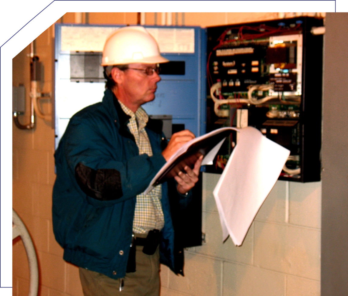 Inspector examining electrical panel with notes.